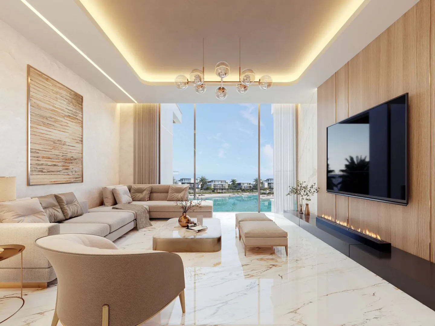 Bright living room with beige sectional, chair, and marble floors. Large windows overlook the ocean. A TV and fireplace are on a wood-paneled wall.