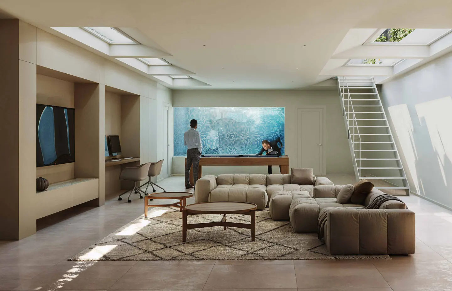 A modern living room with a pool table, beige sectional sofa, and a white staircase. Two men are playing pool in front of a large aquarium.