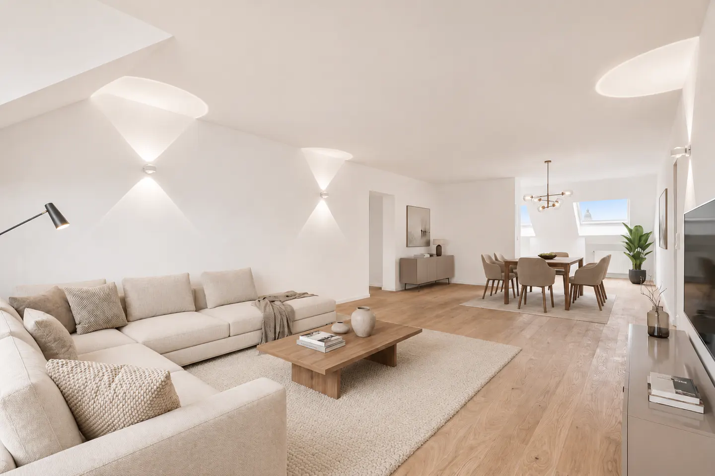 Modern open-plan living room with beige sectional sofa, wooden coffee table, and dining area on light hardwood floors.