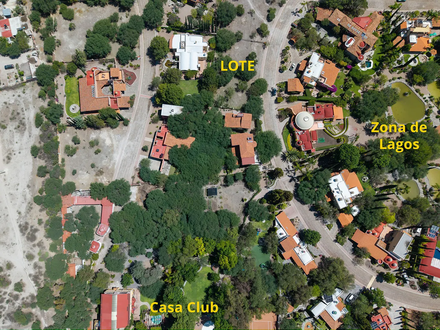 Aerial view of a residential area with houses, trees, and roads. Some areas are labeled "LOTE", "Zona de Lagos", and "Casa Club".