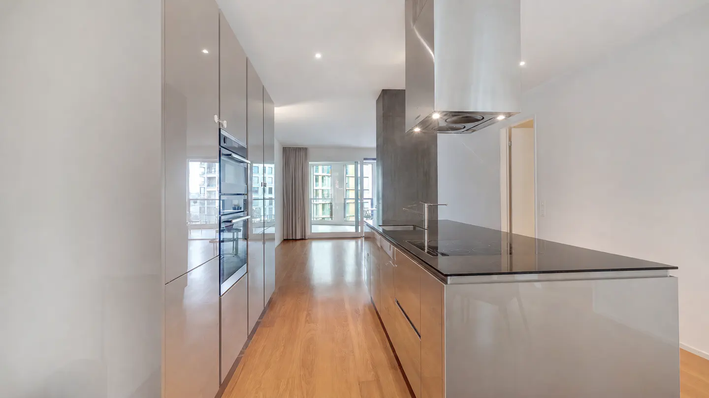 Open-plan living with an elegant designer kitchen, warm wooden flooring and a generous sense of space.