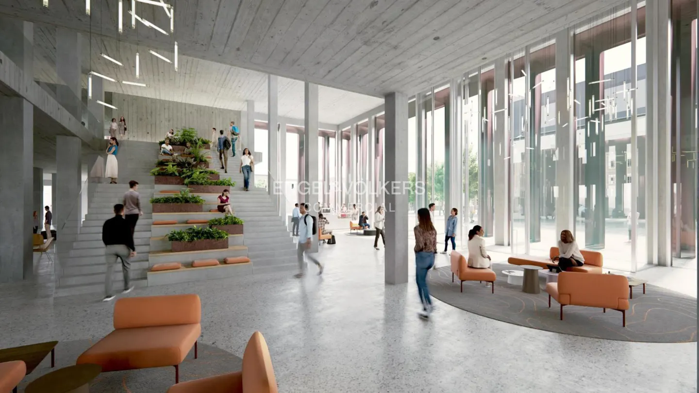 Bright, modern lobby with concrete walls, orange seating, and a staircase with planters. People are walking and sitting.