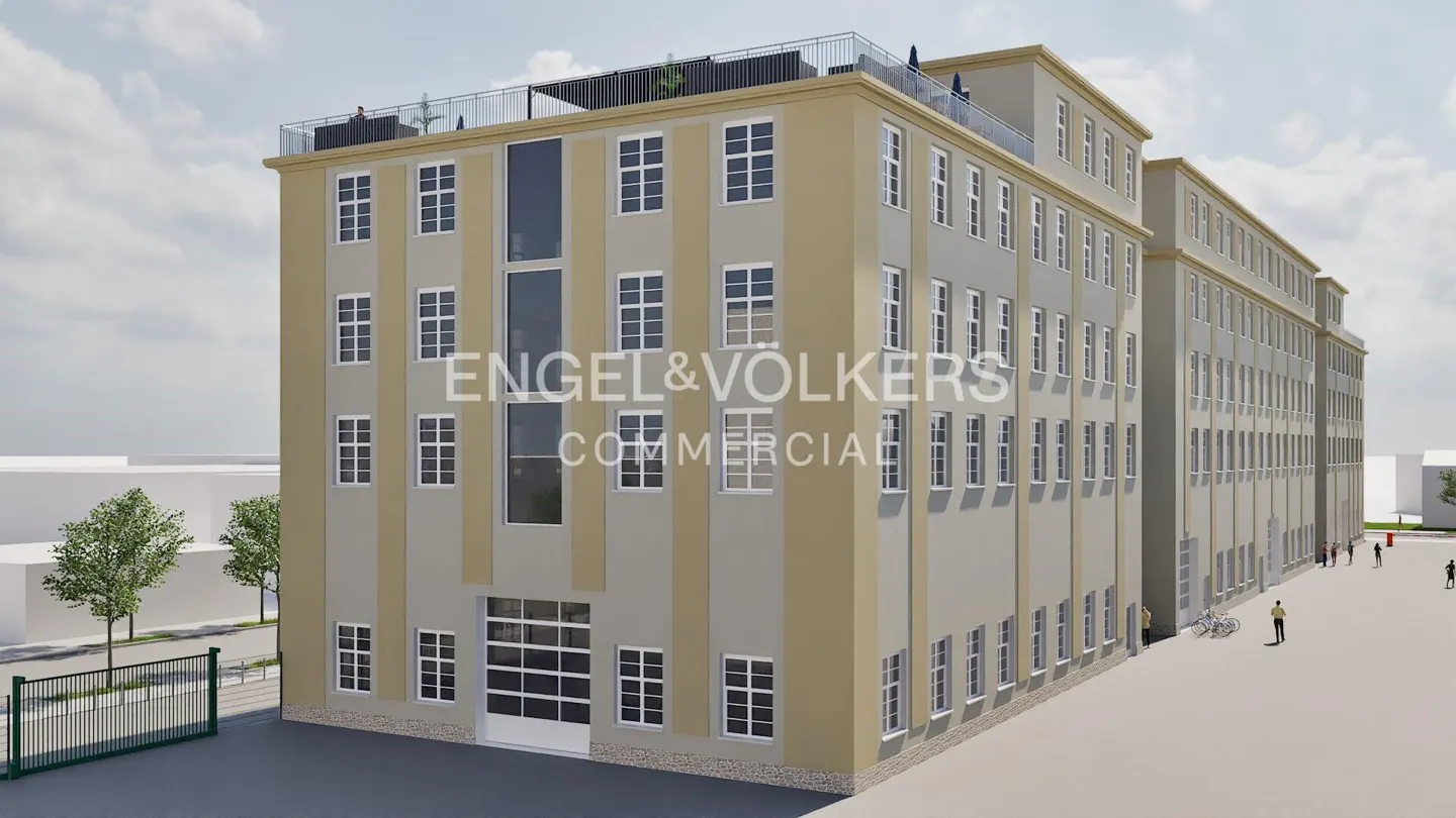 Exterior view of a large, beige commercial building with many windows and the Engel & Völkers logo. A rooftop terrace is visible.