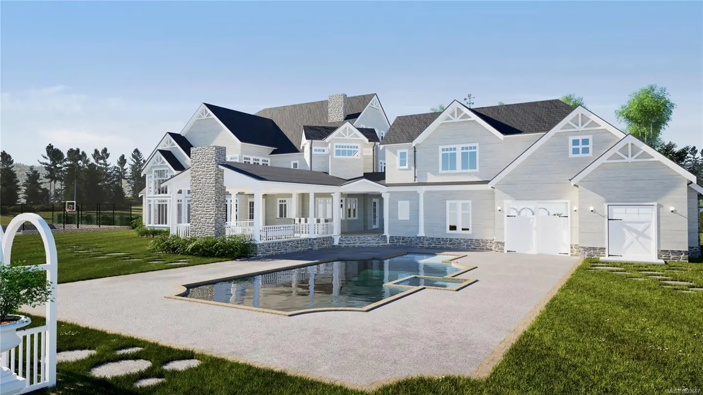 Exterior view of a large, light gray house with a pool, white trim, and a dark roof on a sunny day.