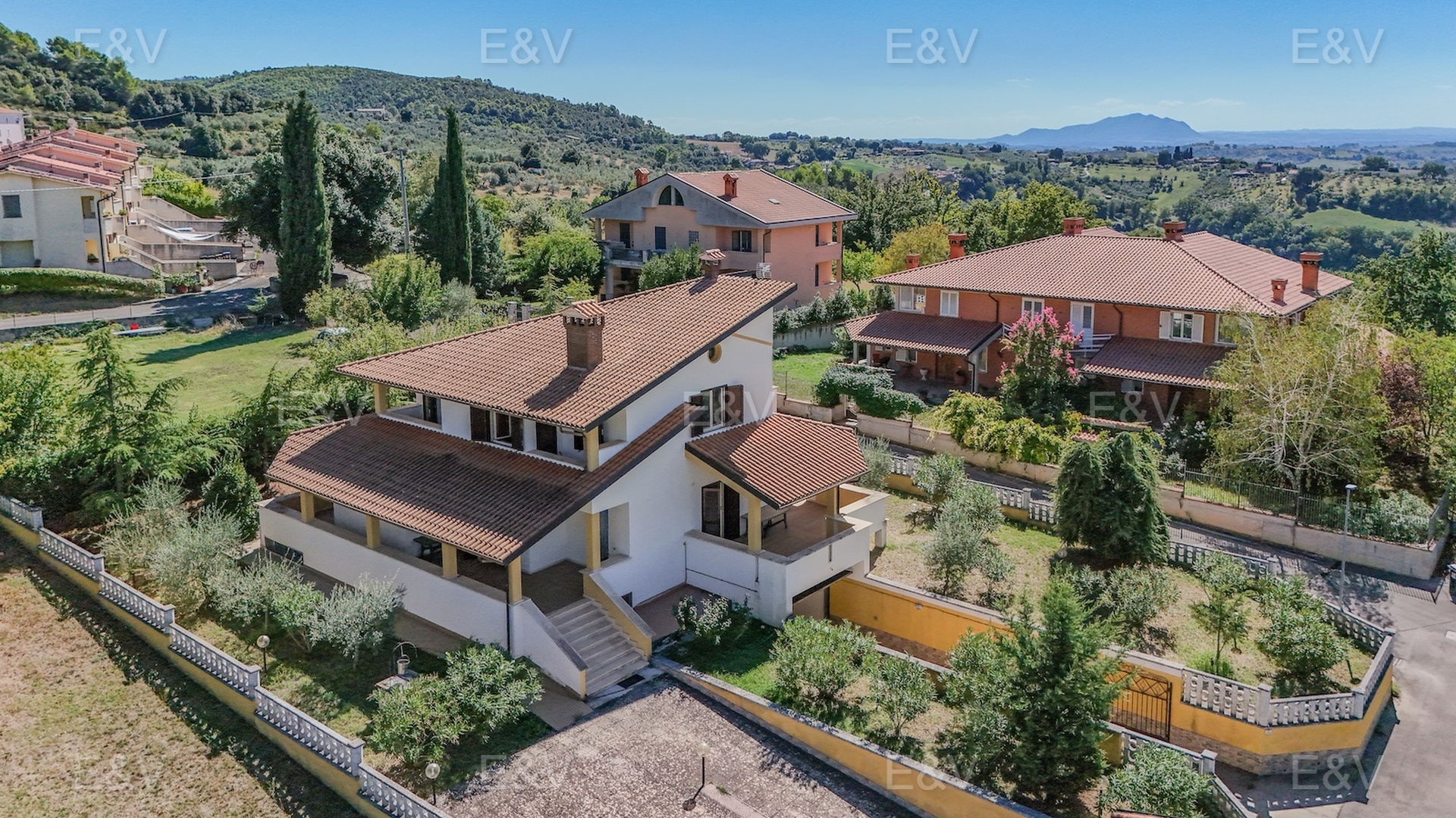 An elegant villa with panoramic views overlooking a charming medieval village