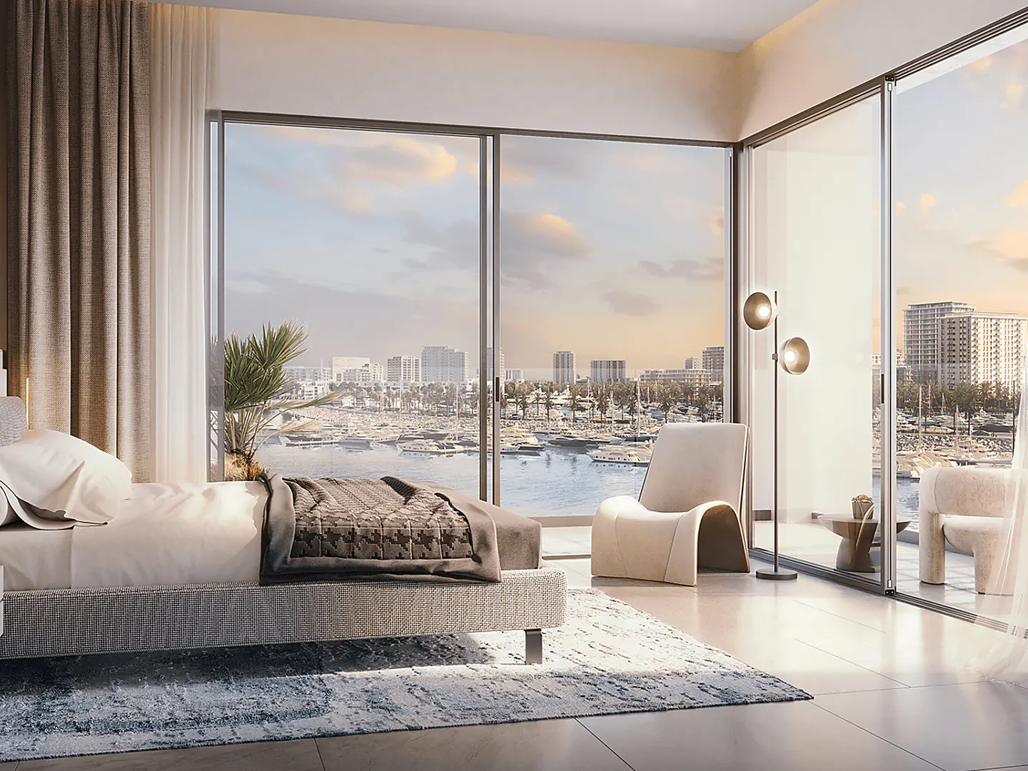 Bedroom with a view of a harbor, featuring a bed, chairs, and a floor lamp. The room has large windows and a neutral color scheme.