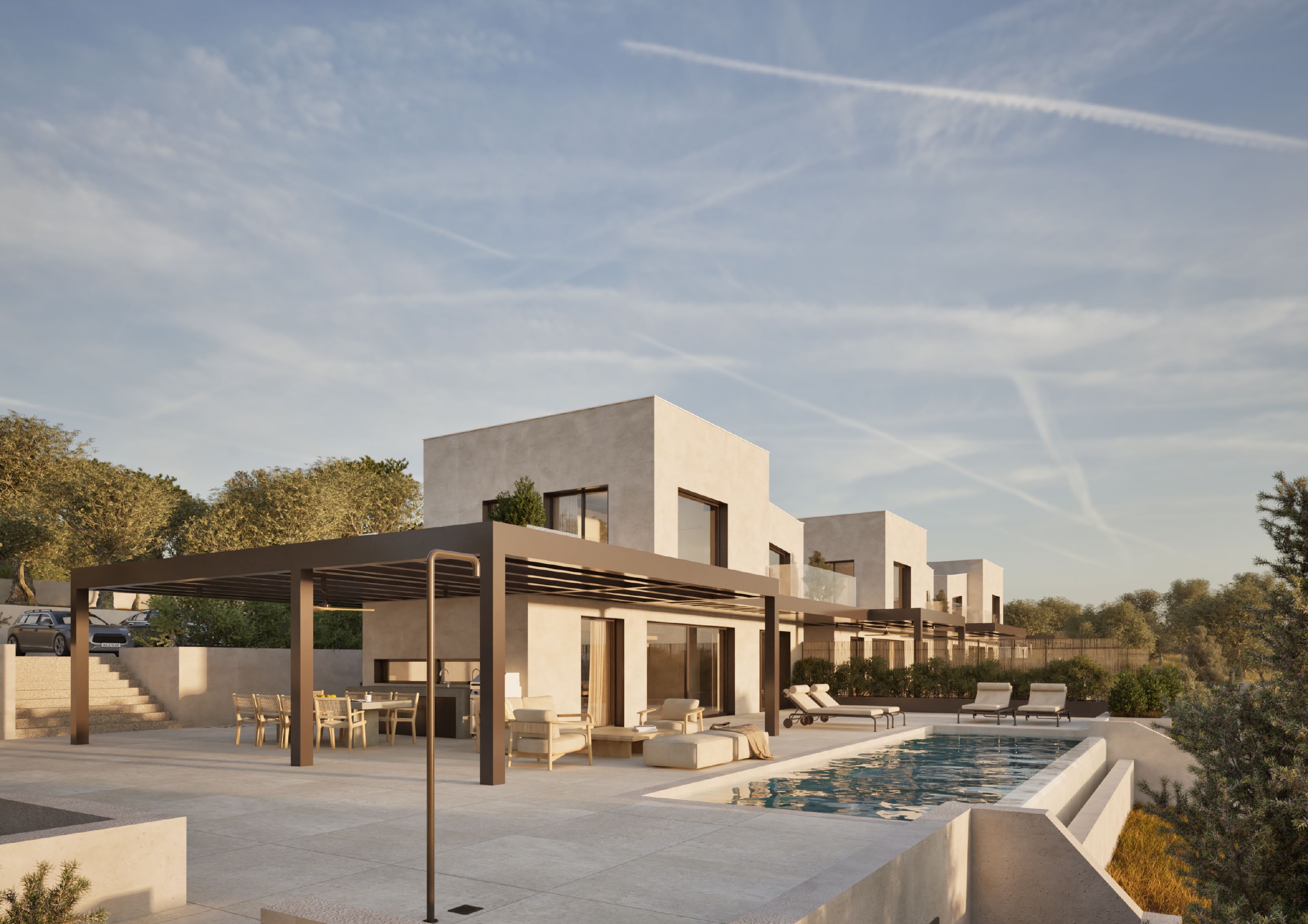 Modern white villas with a pool and patio under a blue sky. Outdoor furniture includes a dining table, chairs, and lounge chairs.