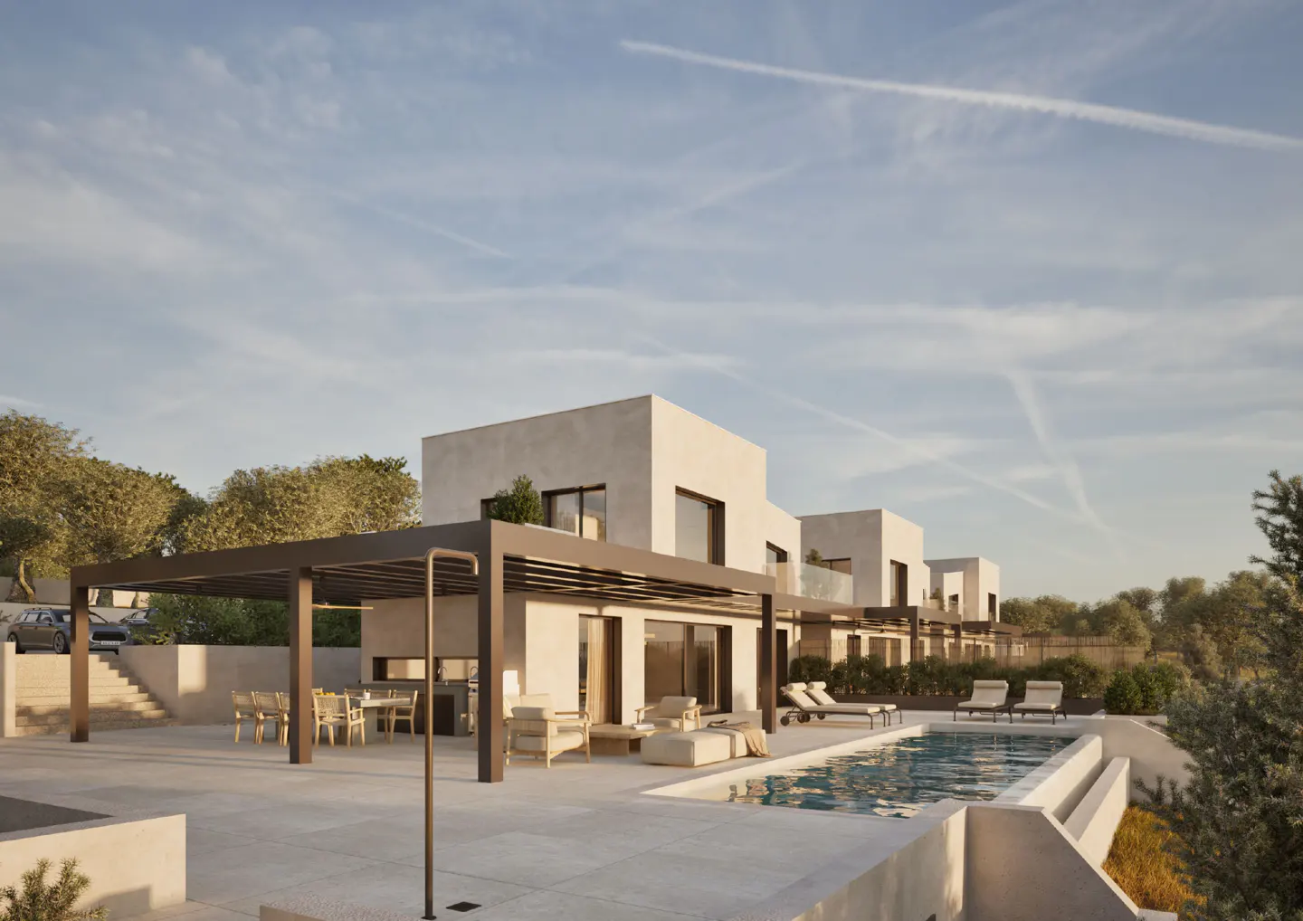 Modern white villas with a pool and patio under a blue sky. Outdoor furniture includes a dining table, chairs, and lounge chairs.