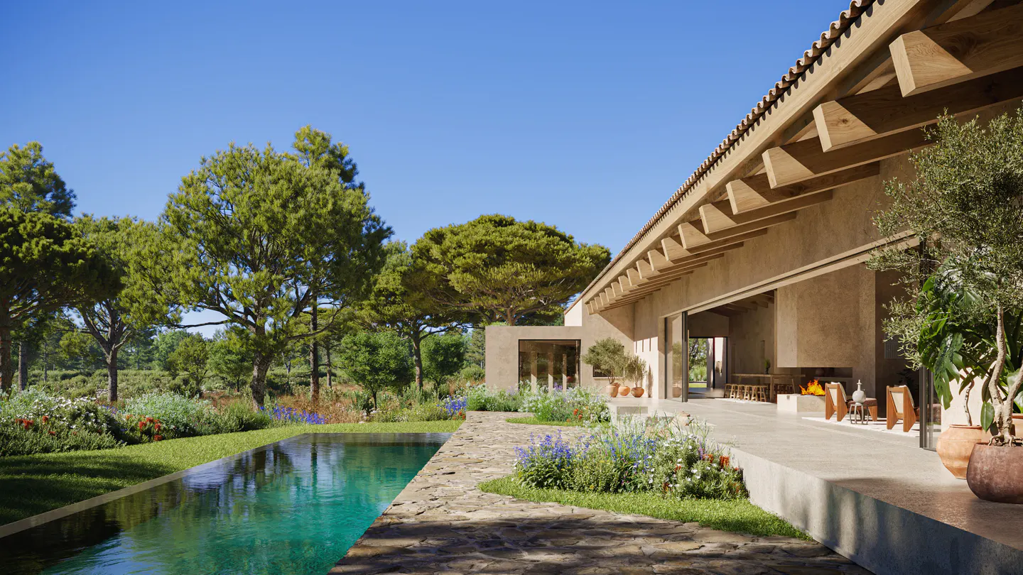 Exterior view of a tan house with a pool, stone patio, and lush garden under a clear blue sky.