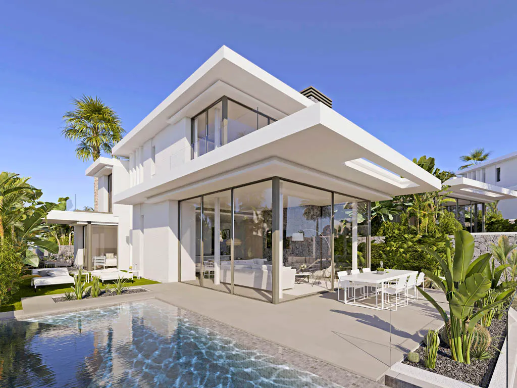 Modern white house with a pool. Large glass windows reflect the interior. Lush green landscaping surrounds the property.