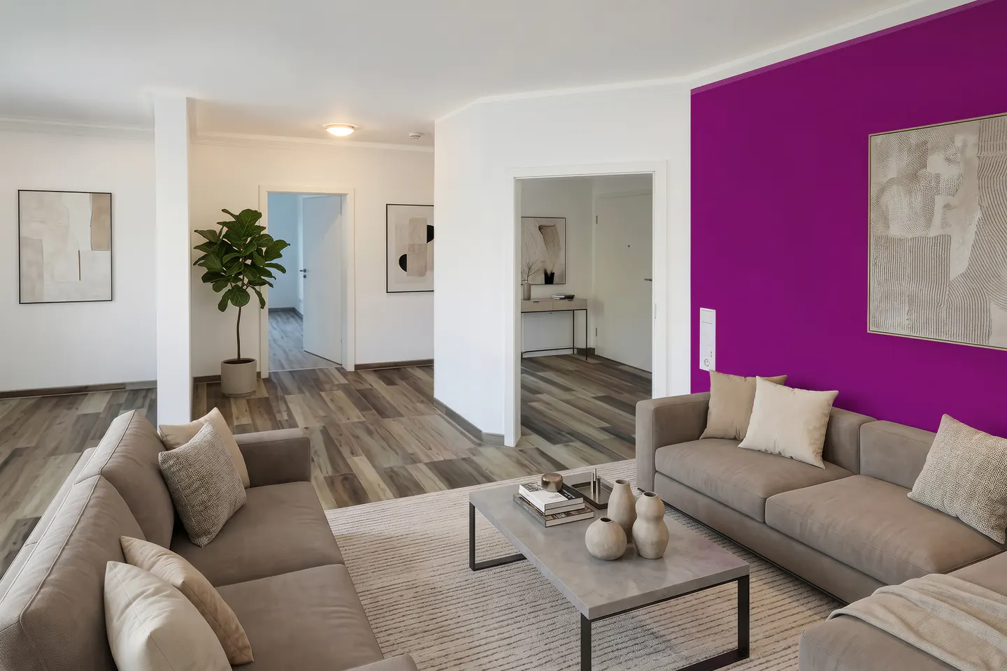 Living room with gray sofas, a gray coffee table, and a purple accent wall with artwork. Hallways lead to other rooms.