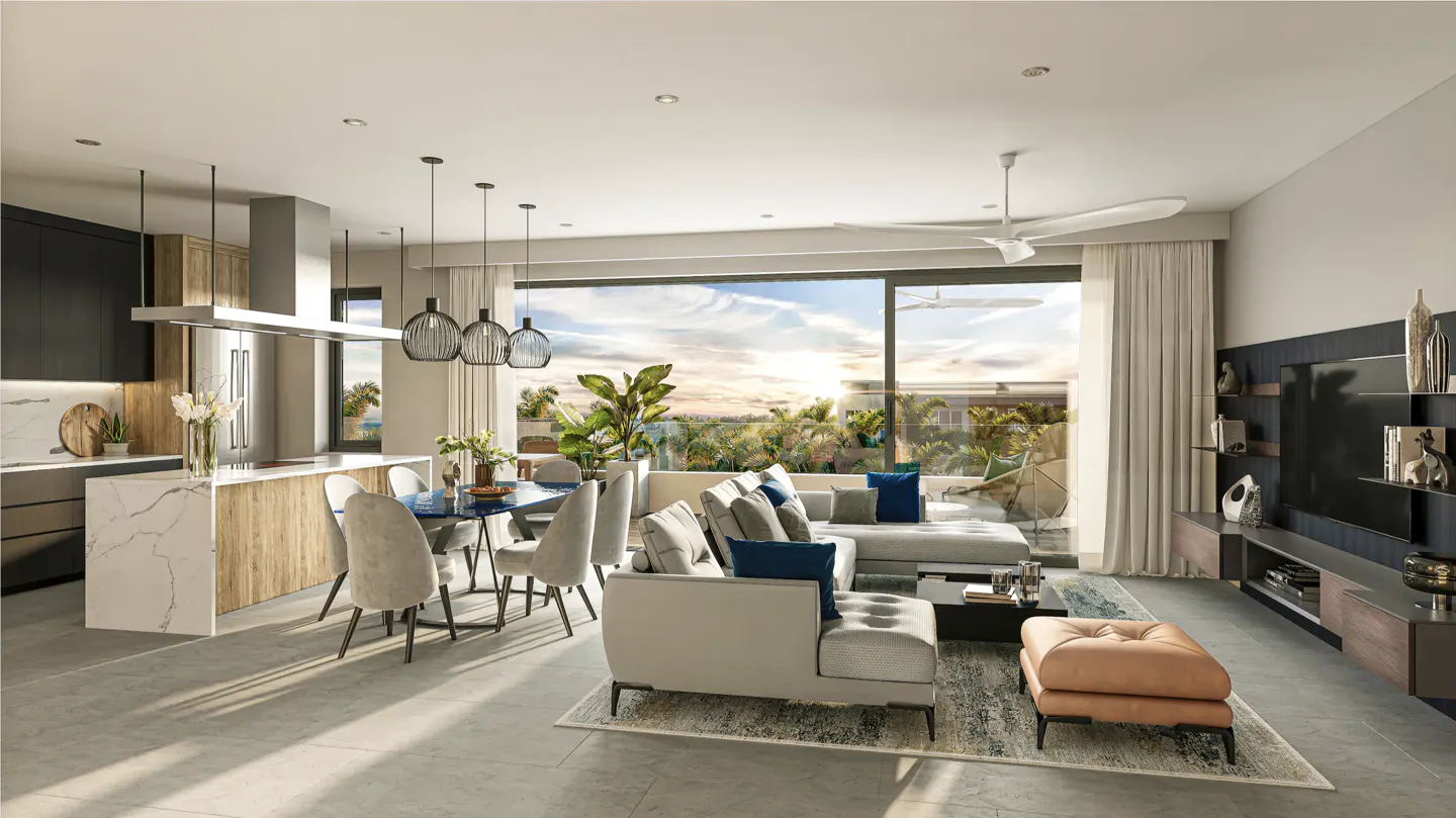 Open-concept living space with kitchen, dining, and living areas. Large windows offer a view of lush greenery and a sunset sky.