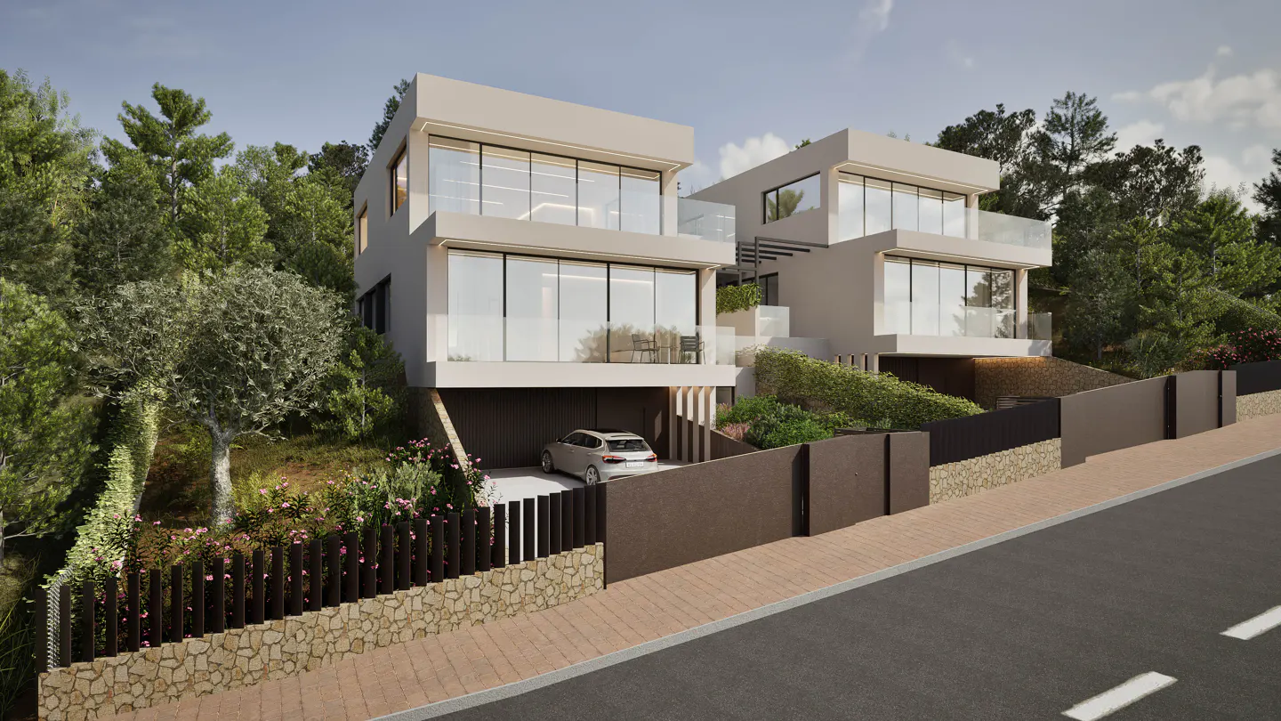 Two modern, boxy, beige homes with large windows sit on a hill surrounded by trees. A car is parked in the garage of the first home.