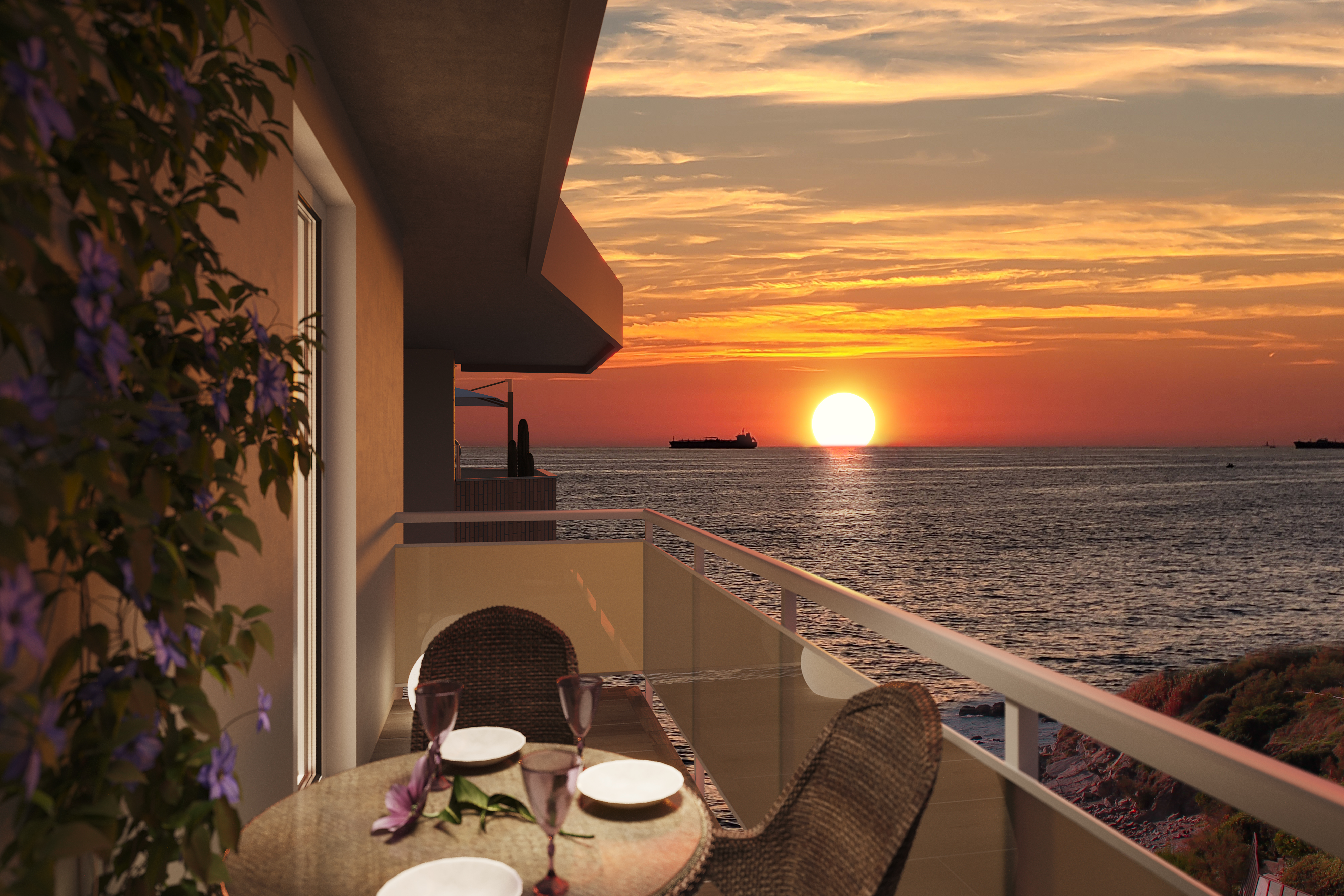 Balcony with a small table and chairs overlooking a vibrant orange sunset over the ocean with a ship on the horizon.