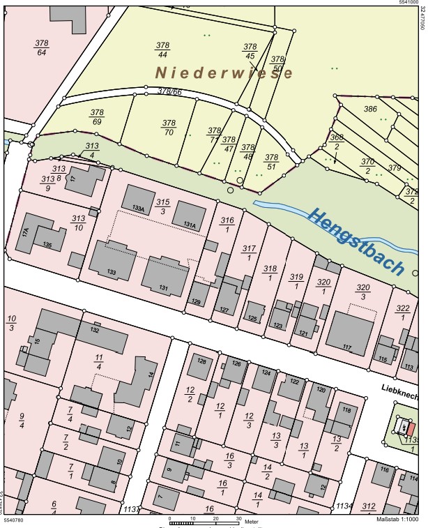A detailed cadastral map showing property boundaries, building footprints, and street layouts in a residential area. [AI-generated text]