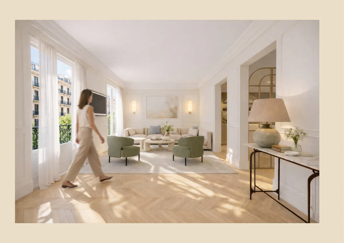 Bright, airy living room with herringbone wood floors. A woman walks by the window. Beige sofa, green chairs, and marble table.