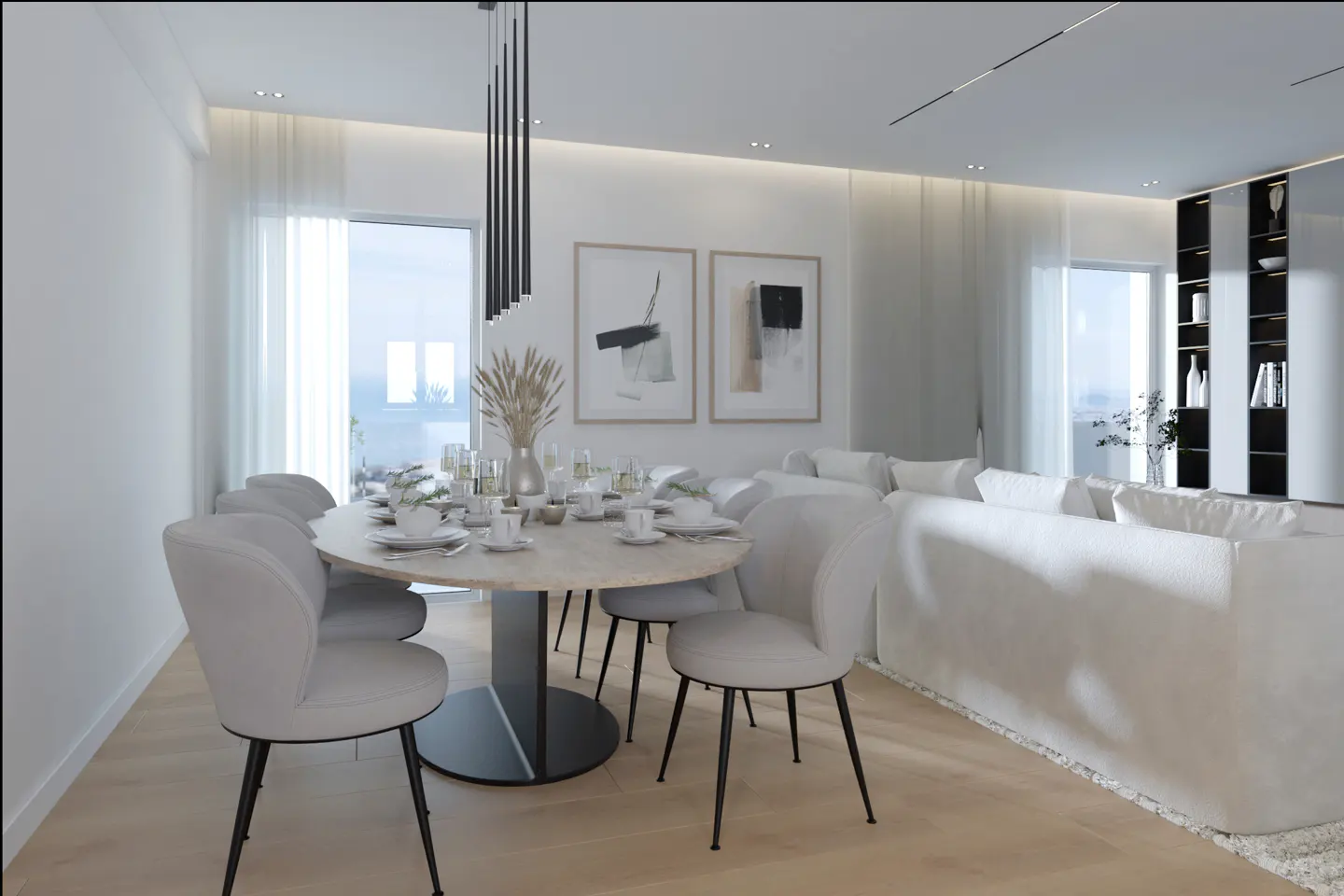 Modern dining area with a round table, white upholstered chairs, abstract wall art, and a white sofa in the background.
