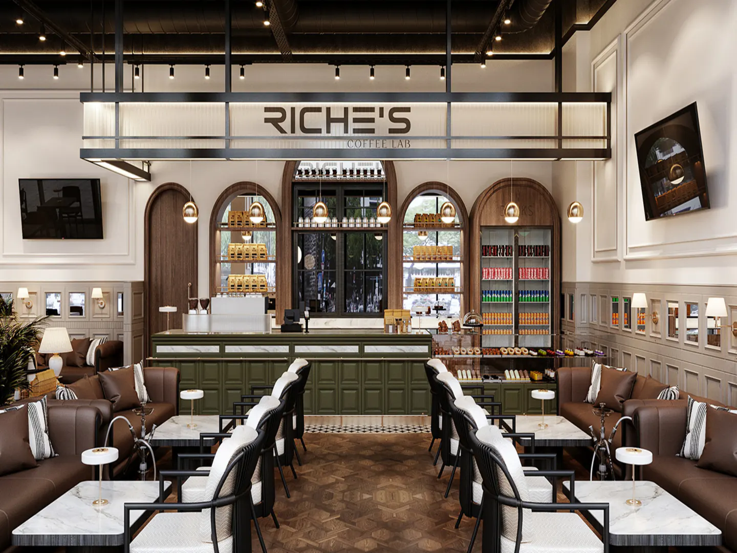 Interior view of Riche's Coffee Lab with brown leather sofas, marble tables, and a green service counter. Arched windows and shelves display products.