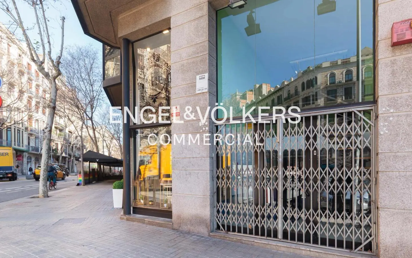Exterior view of Engel & Völkers Commercial office with metal security gate and street view.
