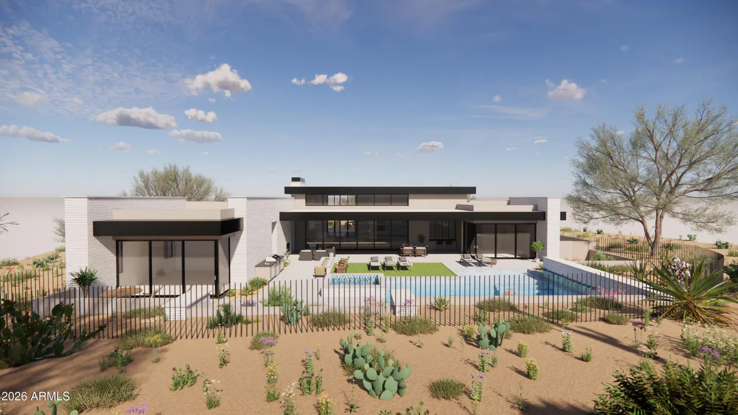 Modern white house with a pool and desert landscaping under a blue sky with clouds.
