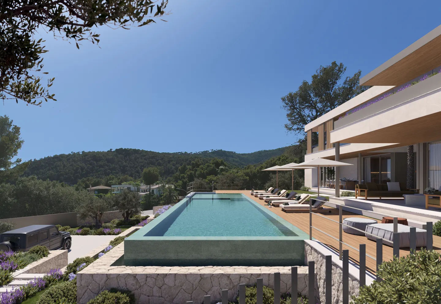 Luxury villa with a long, rectangular pool, lounge chairs, and a view of green hills under a blue sky.