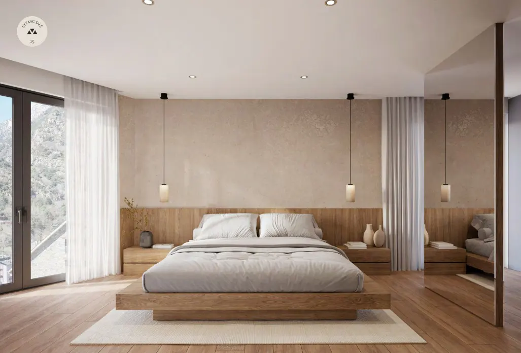 Modern bedroom with a wooden platform bed, light gray bedding, and matching nightstands. Large windows with sheer curtains let in natural light.