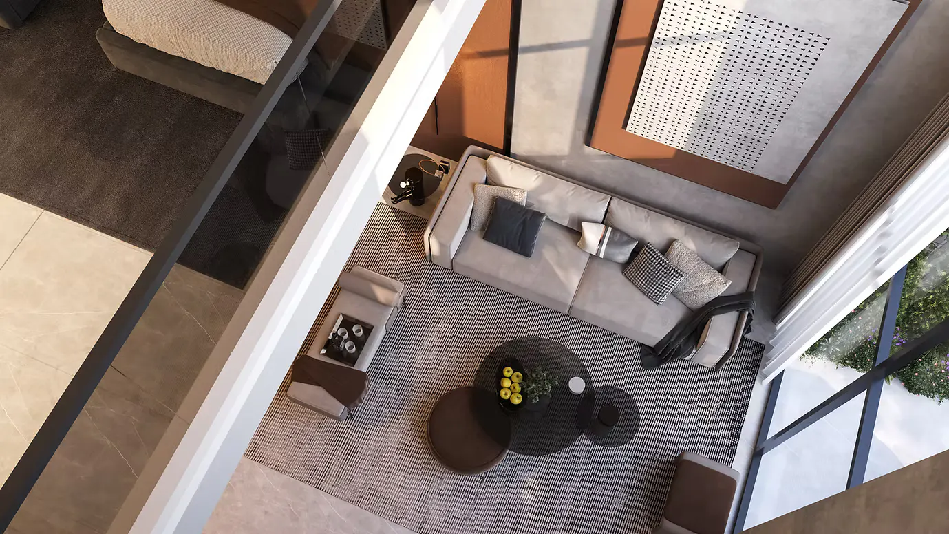 Aerial view of a modern living room with a gray sofa, round coffee tables, and large windows overlooking greenery.