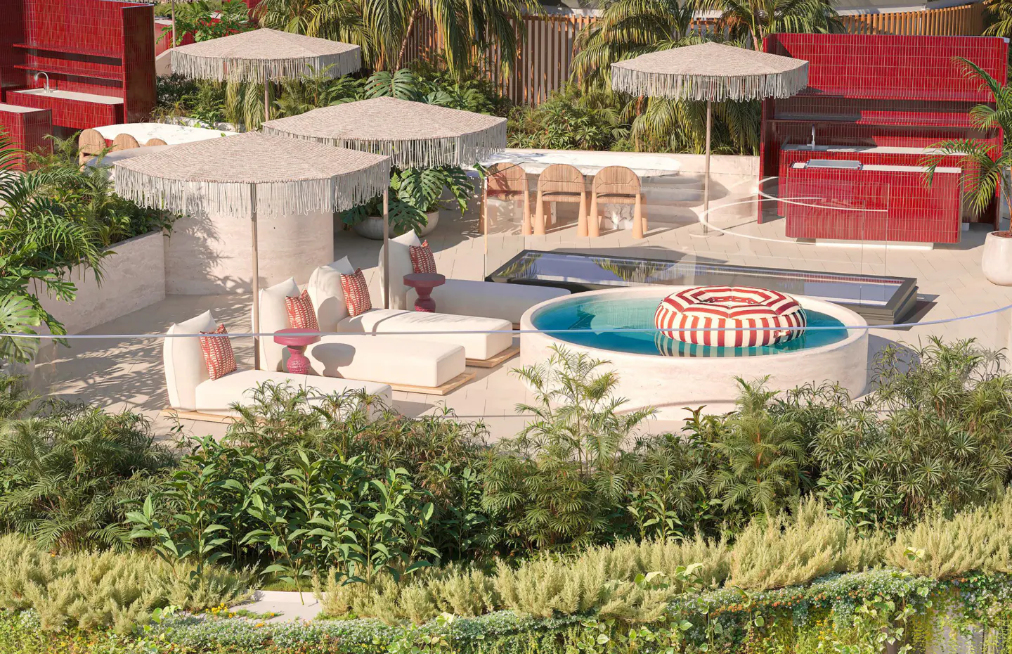 Rooftop patio with lounge chairs, umbrellas, and a round pool with a red and white striped float. Red outdoor kitchen and lush greenery.