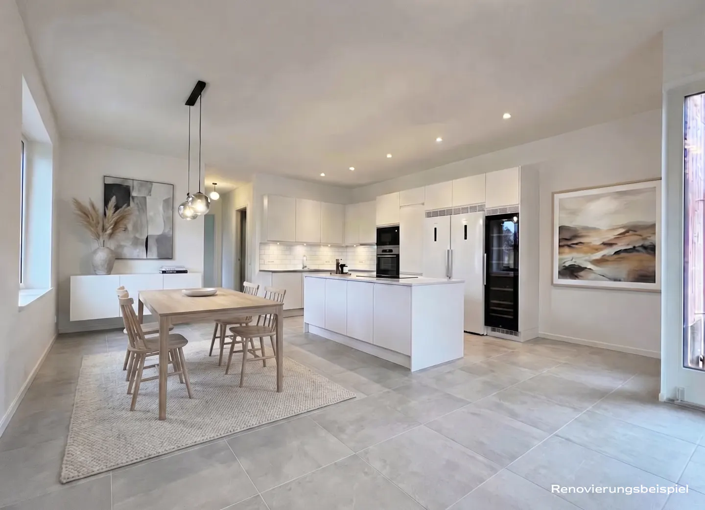 Bright, modern kitchen and dining area with white cabinets, island, and appliances. A light wood table and chairs sit on a neutral rug.