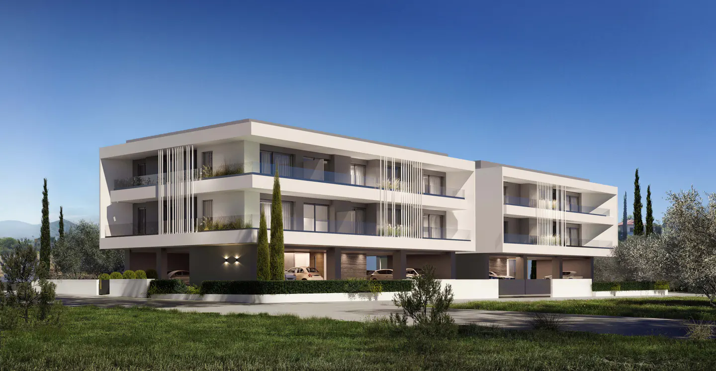 Modern, three-story white apartment building with balconies, green lawn, and blue sky. Cars are parked in the garage.