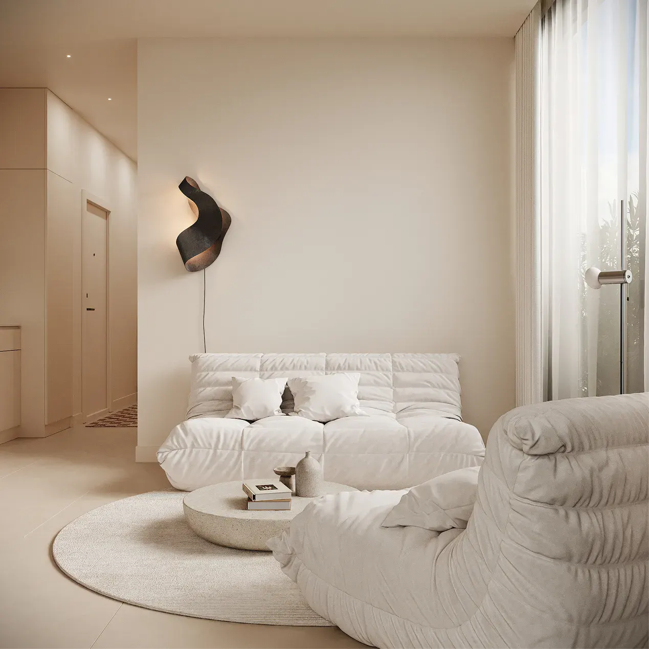 Beige living room with a white sofa, pillows, round rug, and a modern black wall lamp.
