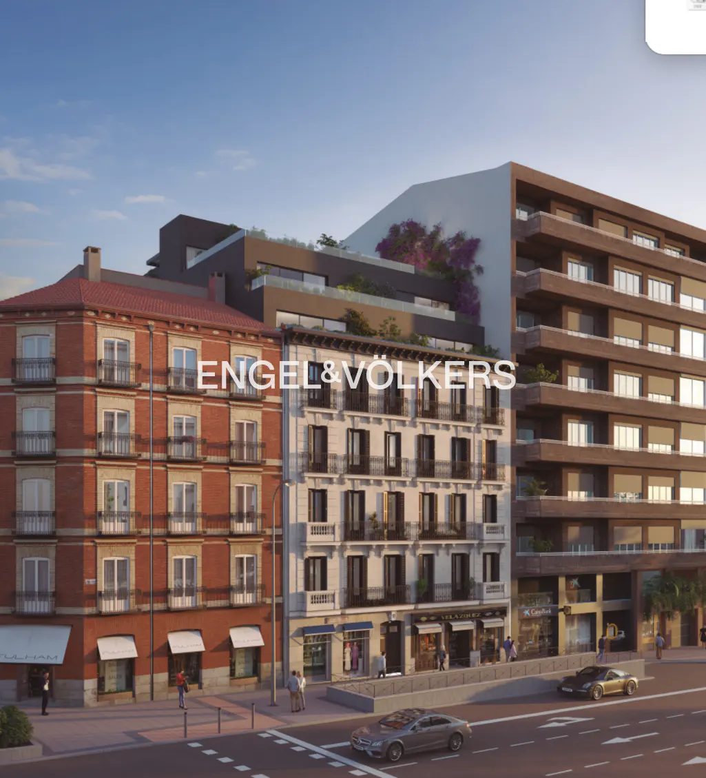 Street view of a red brick building next to a modern white apartment building with the Engel & Völkers logo overlay.