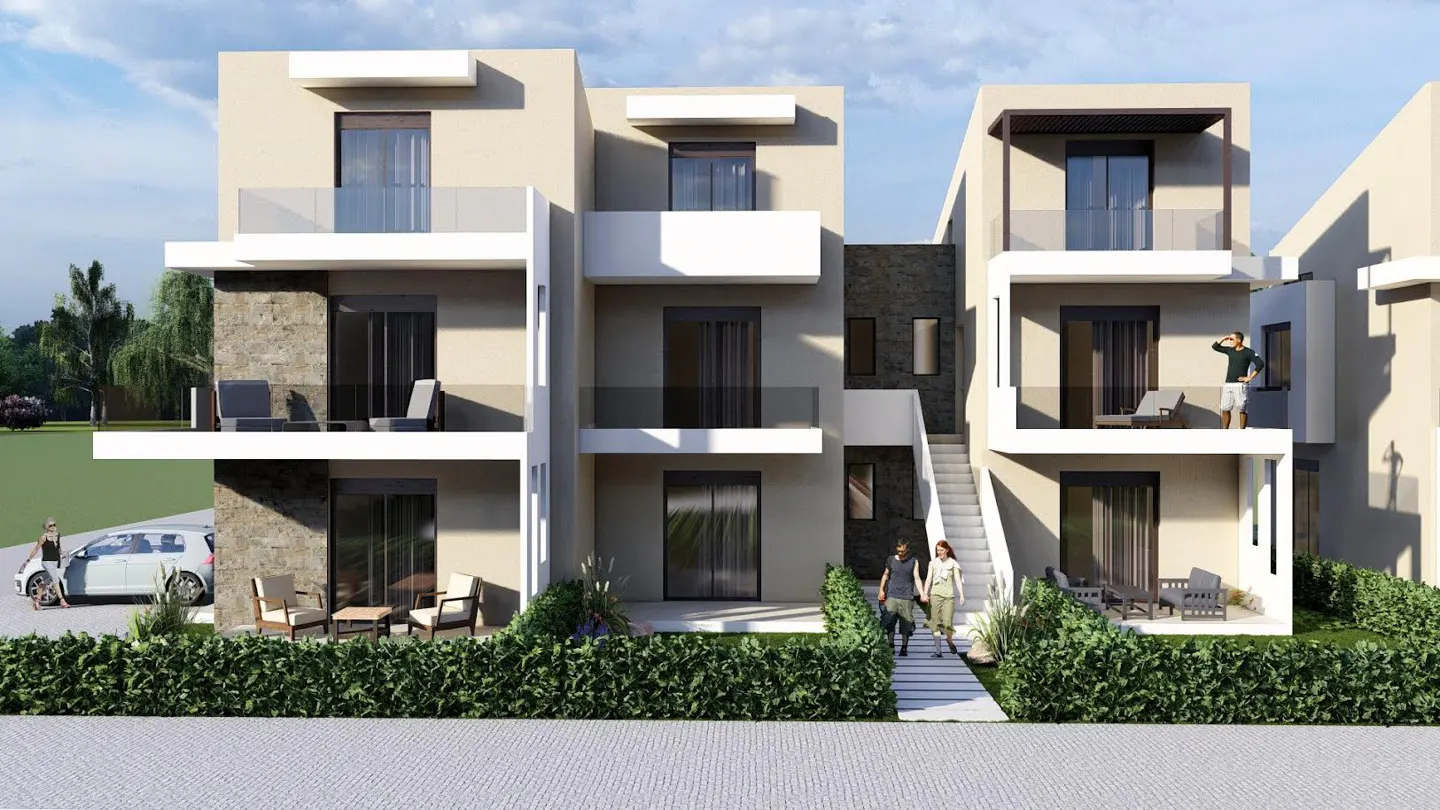 Three-story beige townhouses with balconies, glass railings, and stone accents. People walk on the sidewalk and stand on the balcony.