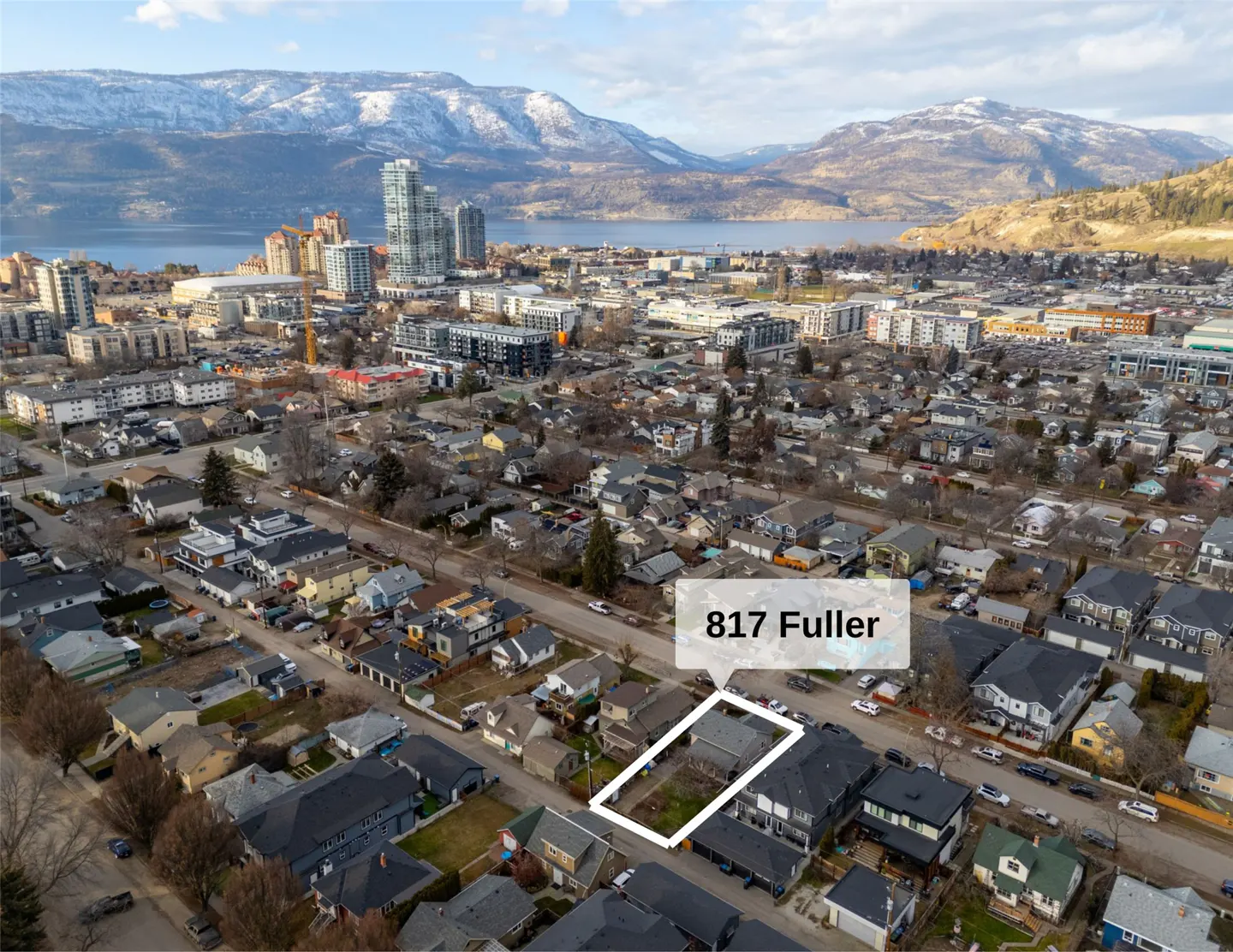 Aerial view of 817 Fuller property in a residential area with city, lake, and mountain views. The property is outlined in white.