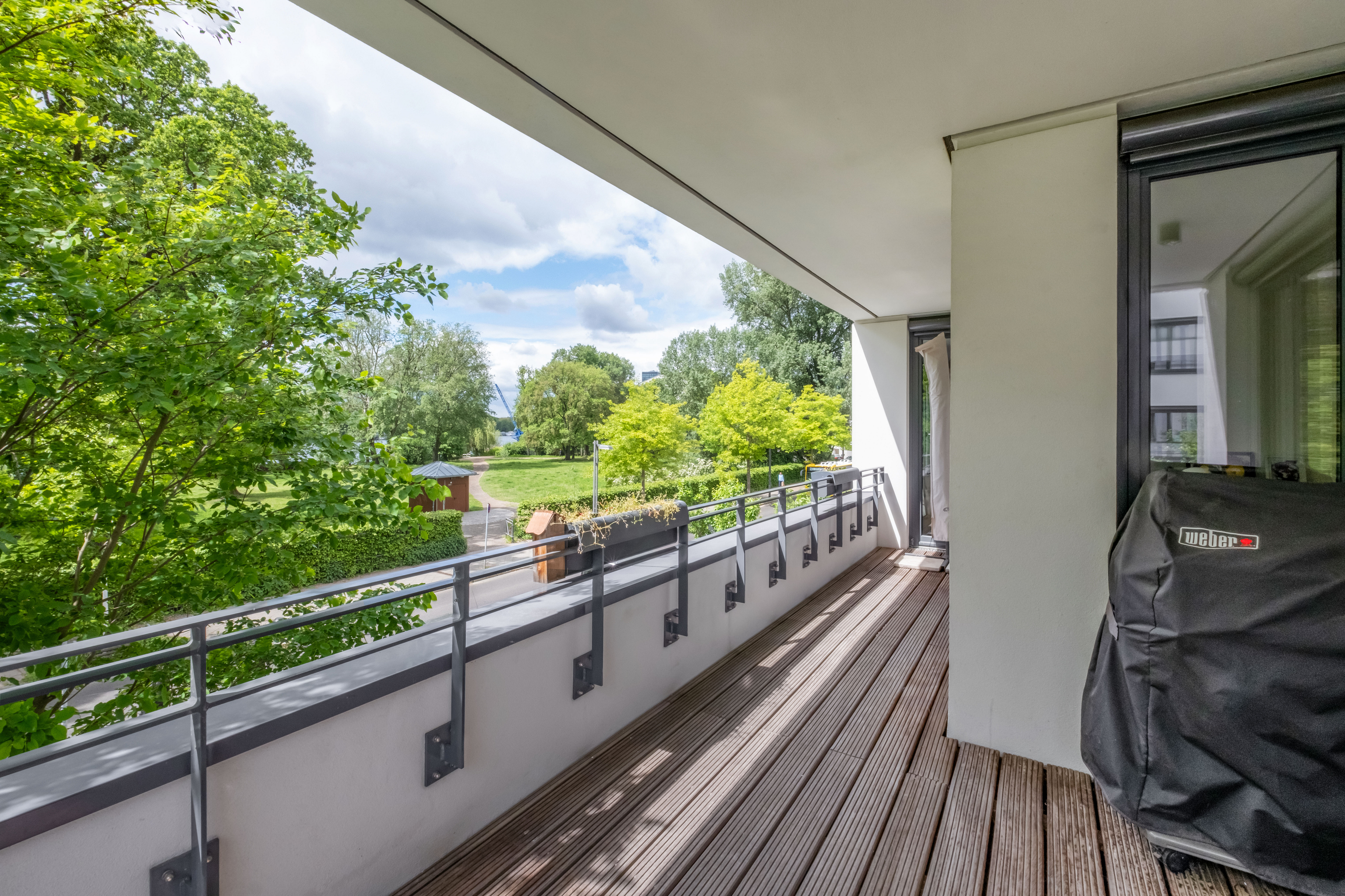 Loggia mit Blick auf Bucht und Baumkronen der Halbinsel Stralau