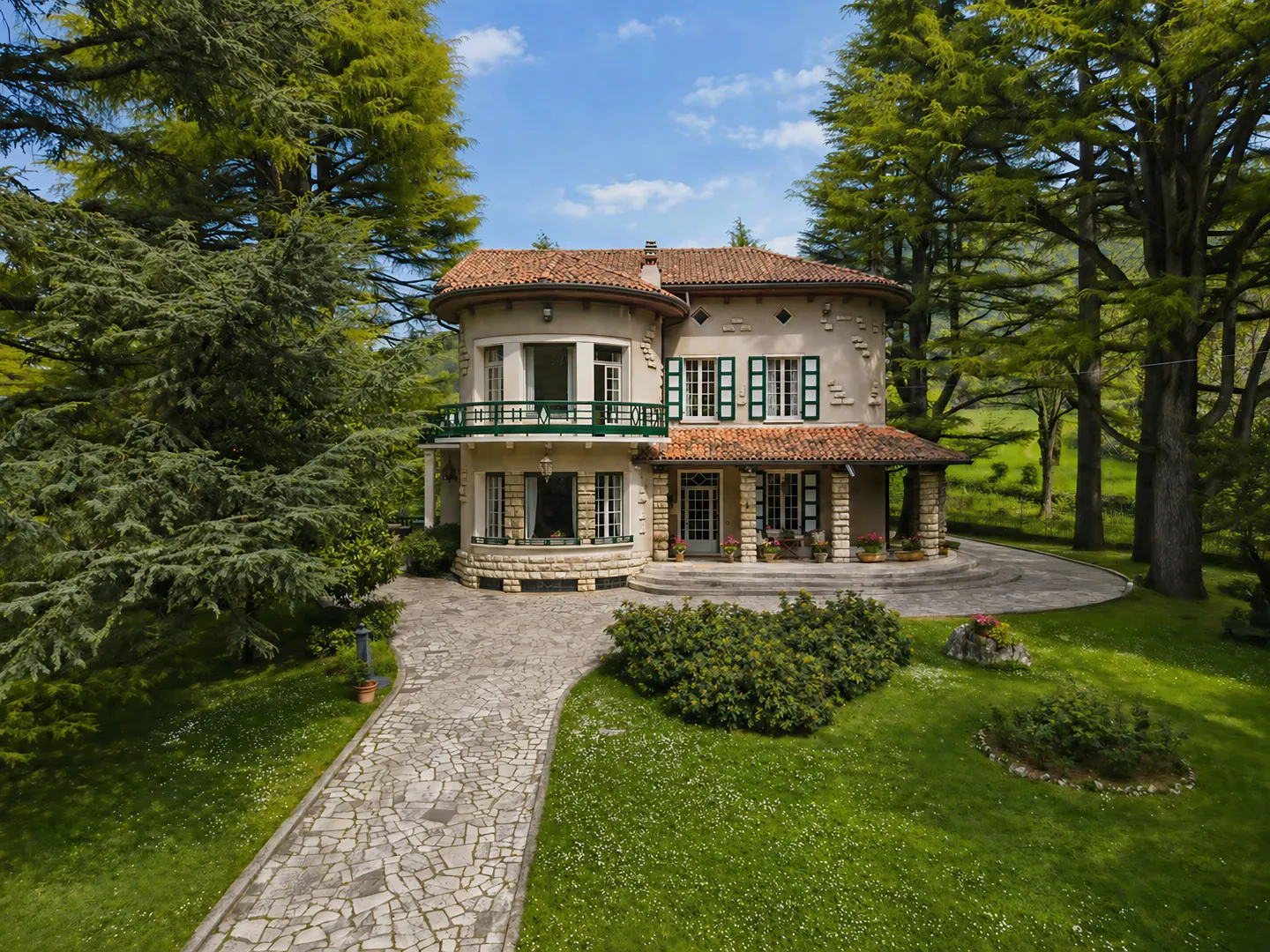 Two-story beige house with a red tile roof, green shutters, and a stone walkway on a green lawn with trees.