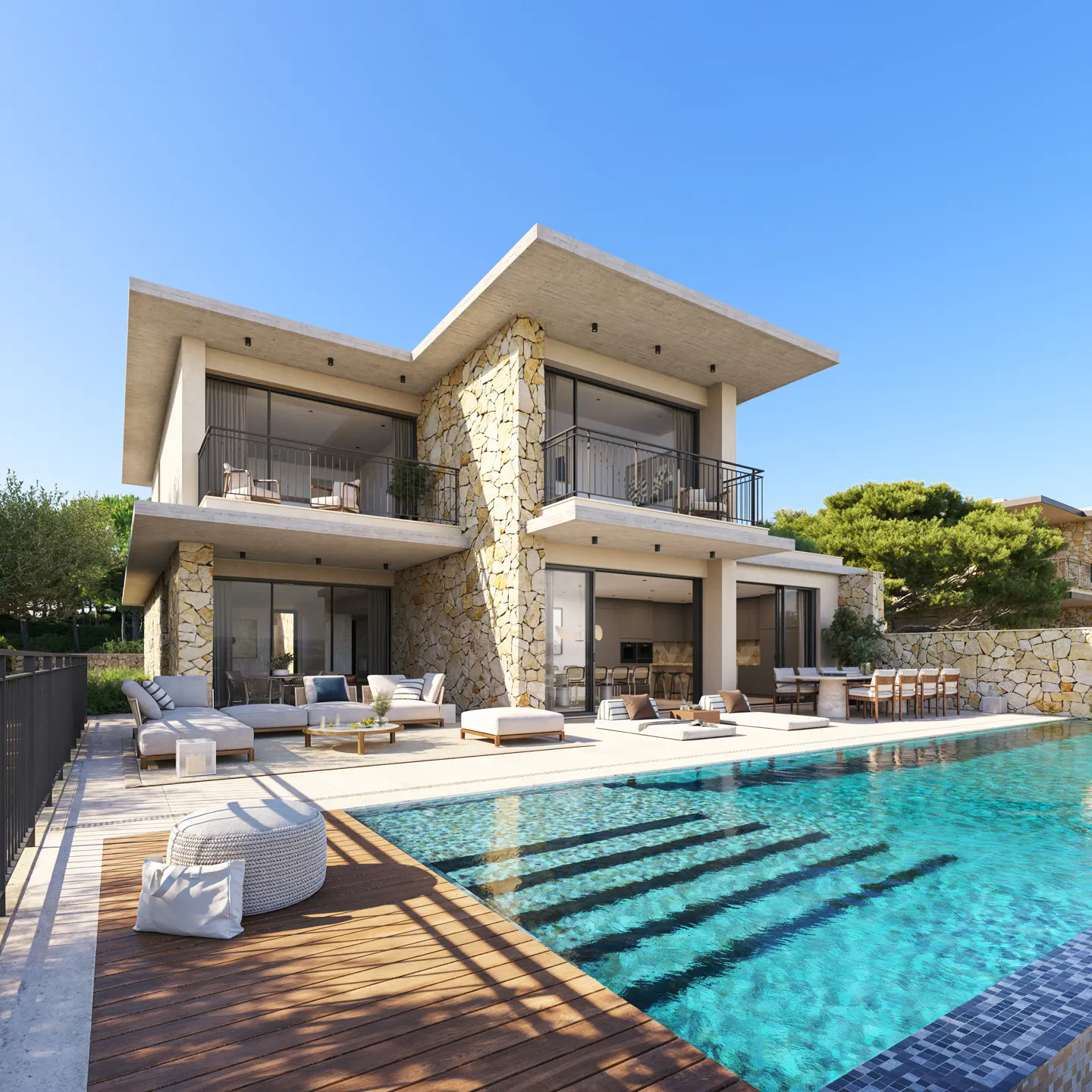 Modern two-story house with a stone facade and a pool. Outdoor furniture is arranged on the patio. Blue sky above.