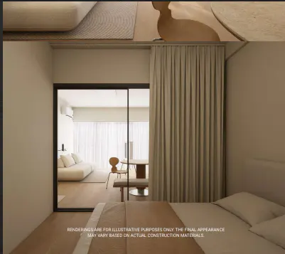 Bedroom view through a glass door, showing a living room with a white sofa and dining area. Beige curtains hang beside the bed.