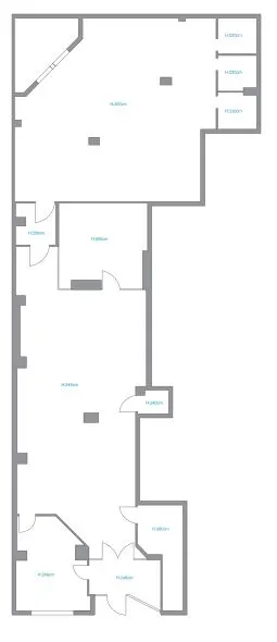 A 2D floor plan showing the layout of a multi-room property with gray walls and white interior spaces.