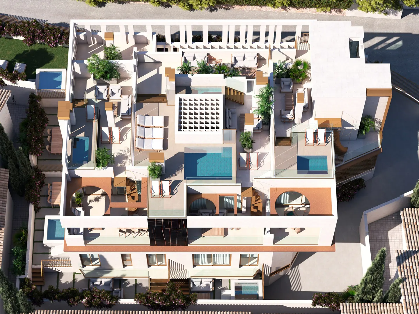 Aerial view of a modern, multi-level white building with pools, patios, and greenery. Outdoor furniture and architectural details are visible.