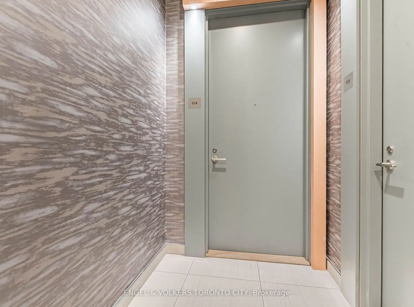 Hallway with gray wallpaper, white tile floor, and two gray doors labeled 104 and 105.