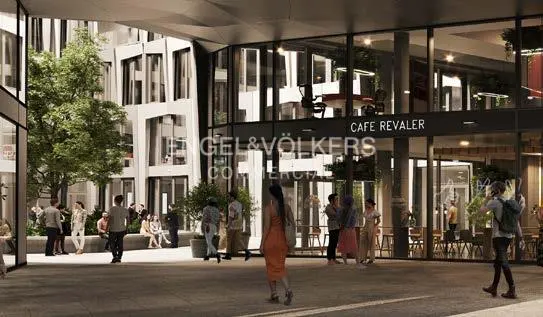 Exterior view of Cafe Revaler with Engel & Volkers signage. People are walking and sitting outside the cafe.