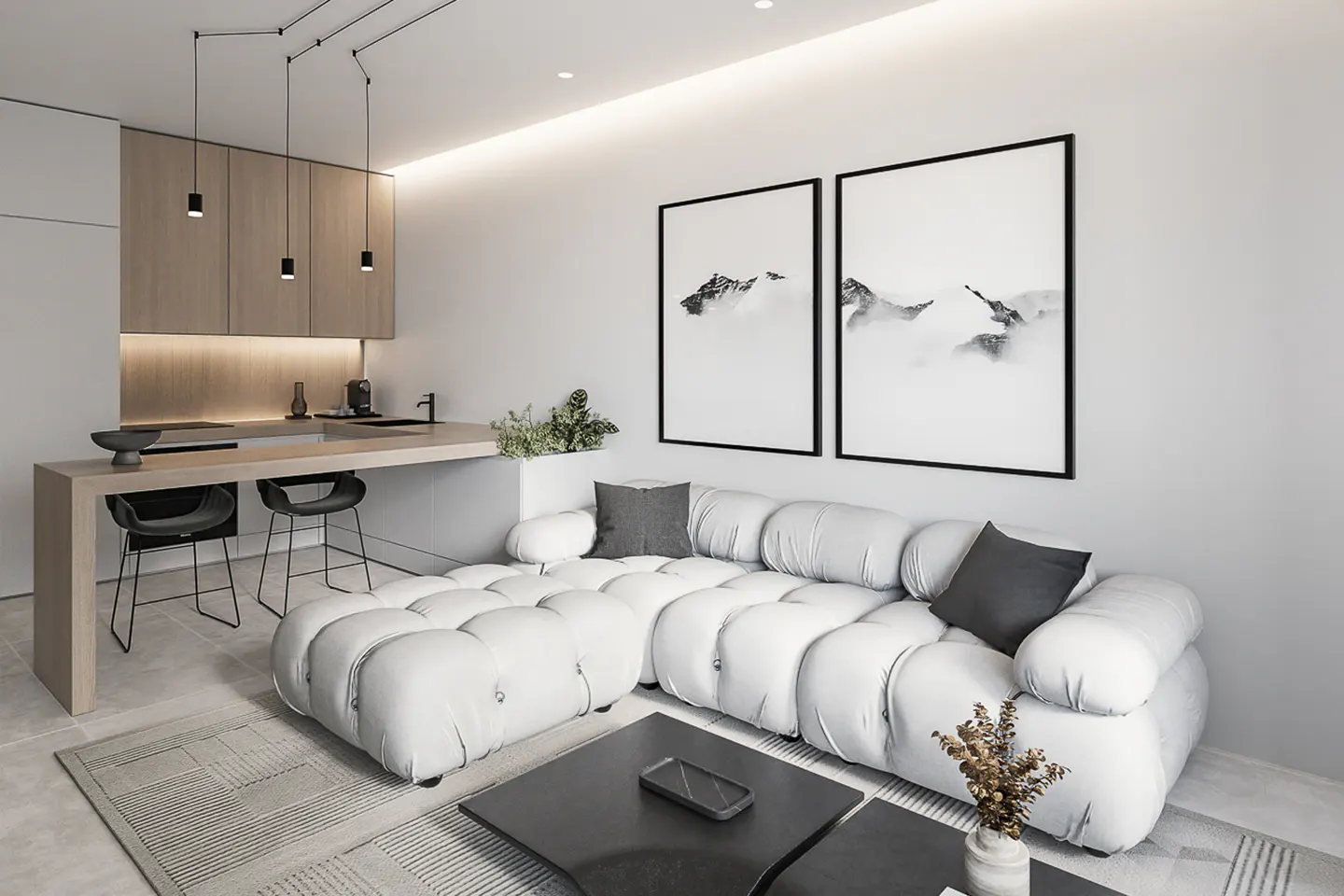 Modern living room with a white sectional sofa, black coffee table, and mountain art. Kitchen island with stools in the background.