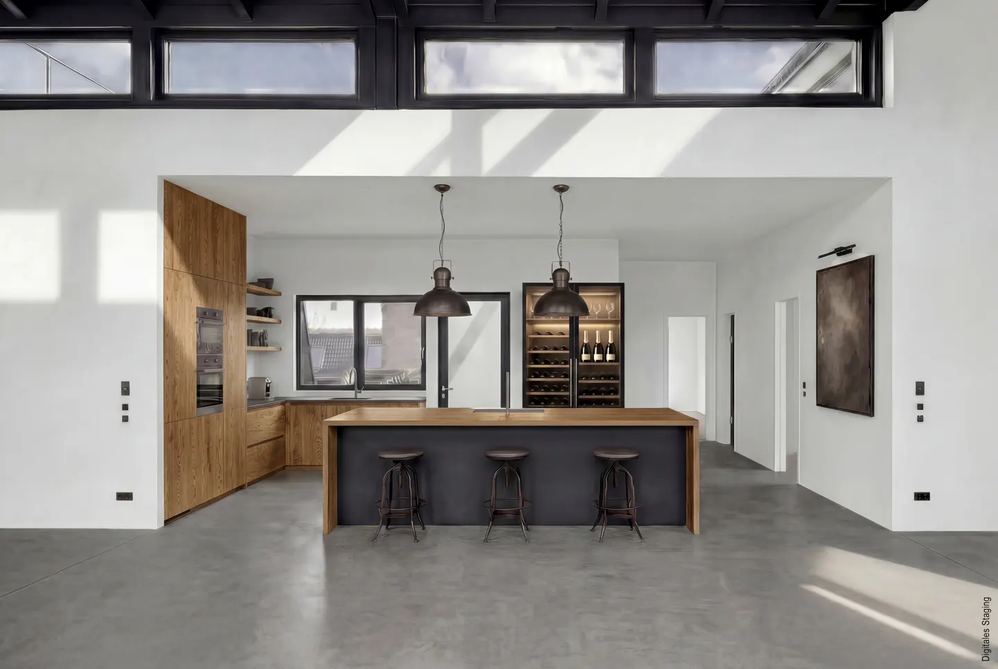 A modern kitchen with a black island, wood cabinets, and concrete floors. Three stools are placed at the island. Overhead are black framed windows.