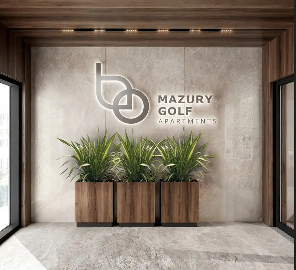 Modern lobby with Mazury Golf Apartments logo on a stone wall, featuring three potted plants in wooden planters.