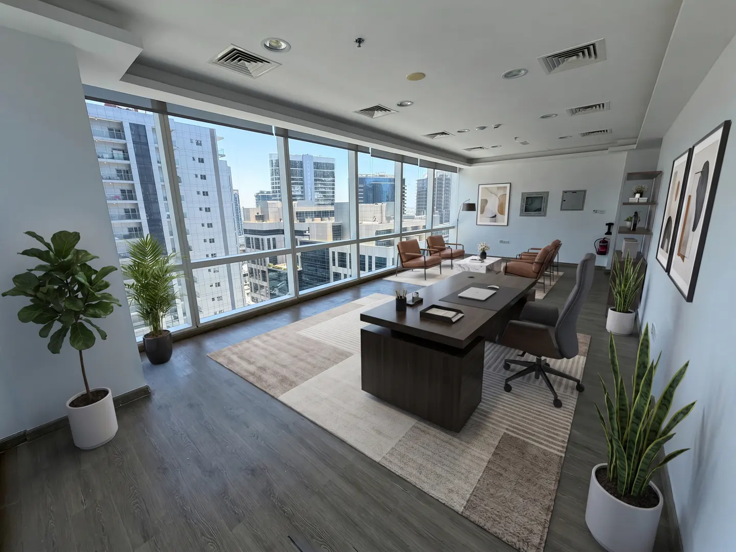 Modern office with a dark wood desk, grey chair, and area rug, featuring floor-to-ceiling windows with city views.