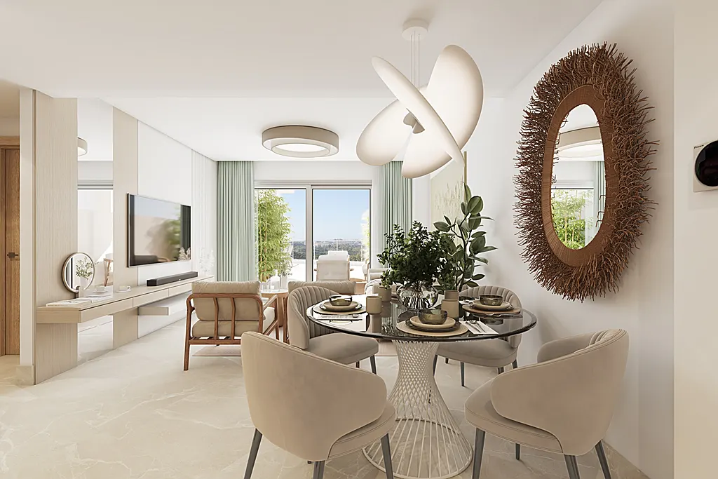 A bright, modern dining area with a round glass table, beige chairs, and a unique twig mirror on the wall. A living room is visible in the background.
