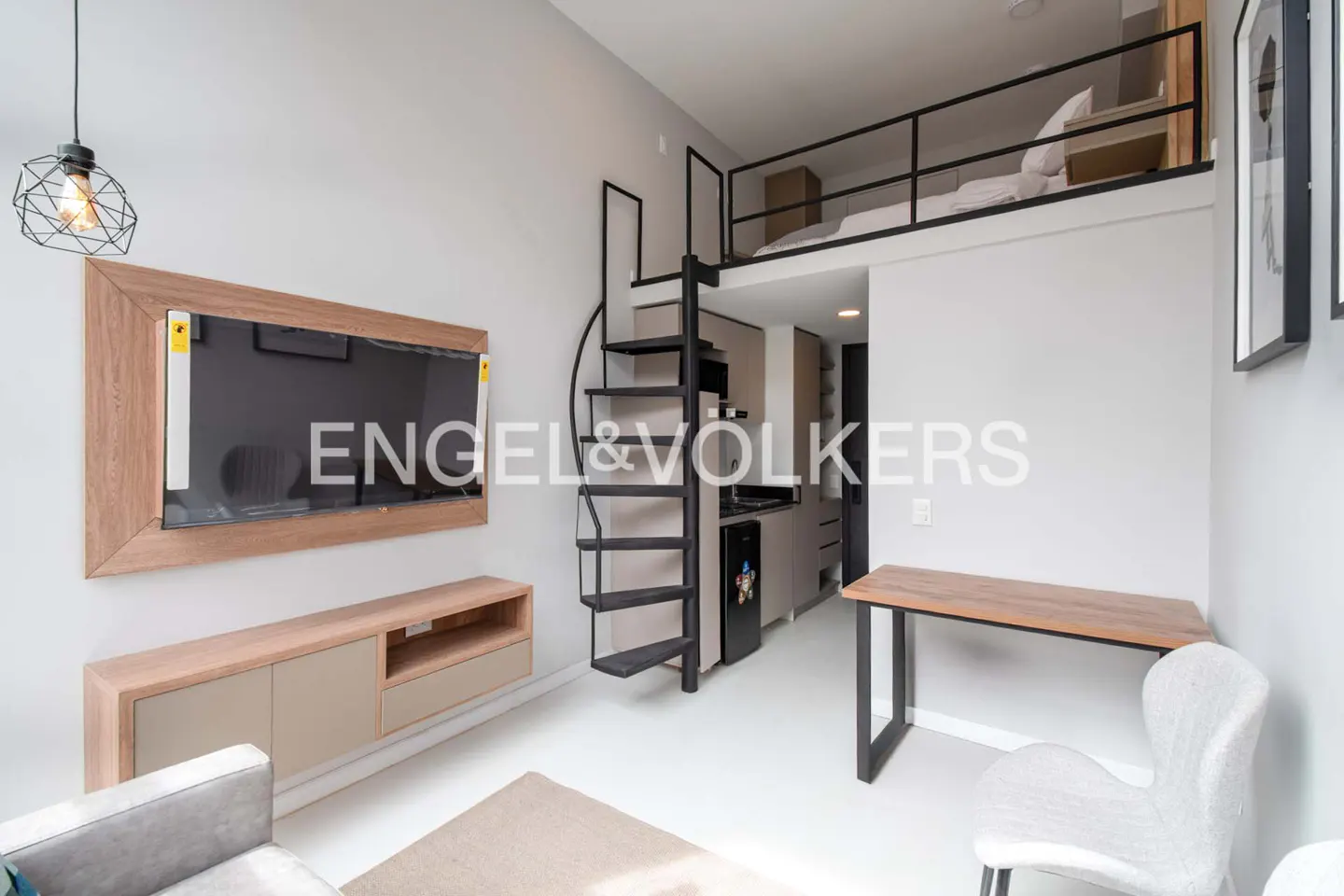 A modern studio apartment with a loft bed, spiral staircase, TV, desk, and chair. The walls are gray and the floor is white.