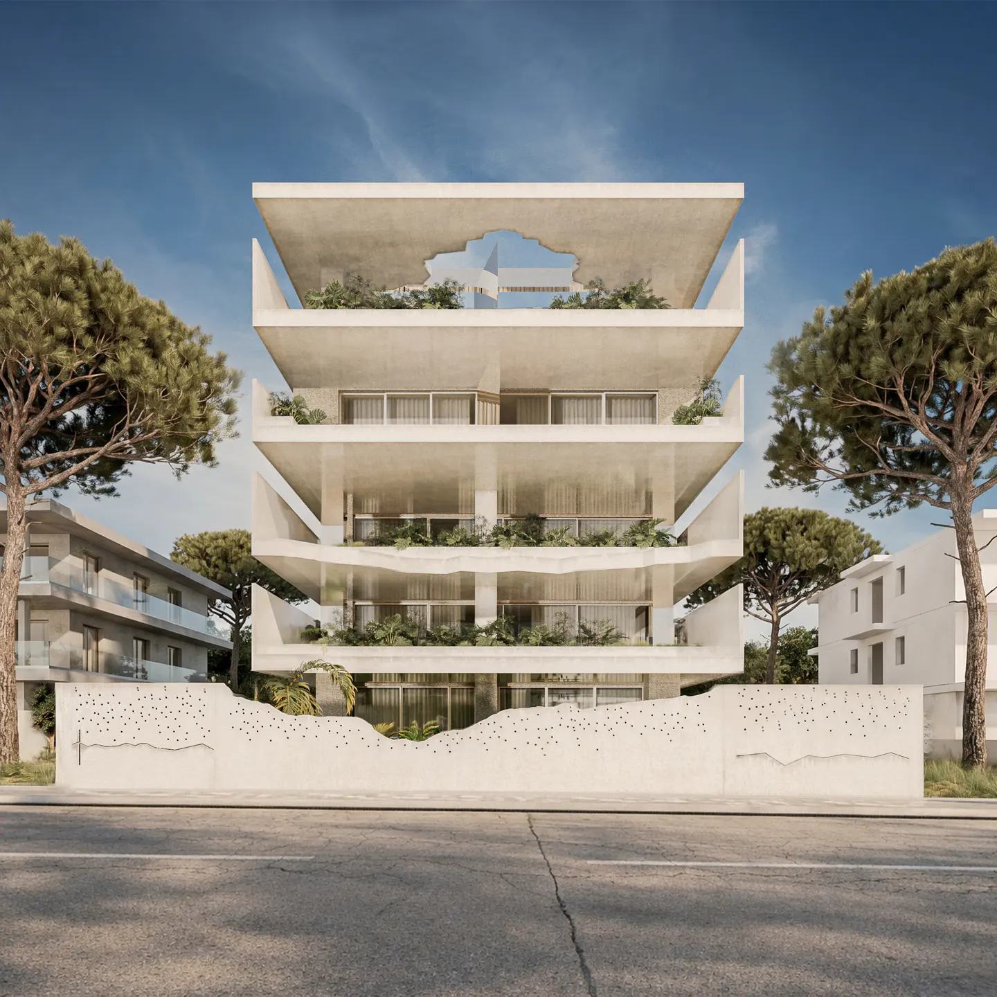 Modern, four-story white apartment building with balconies and greenery, framed by trees under a blue sky. A decorative white wall fronts the street.