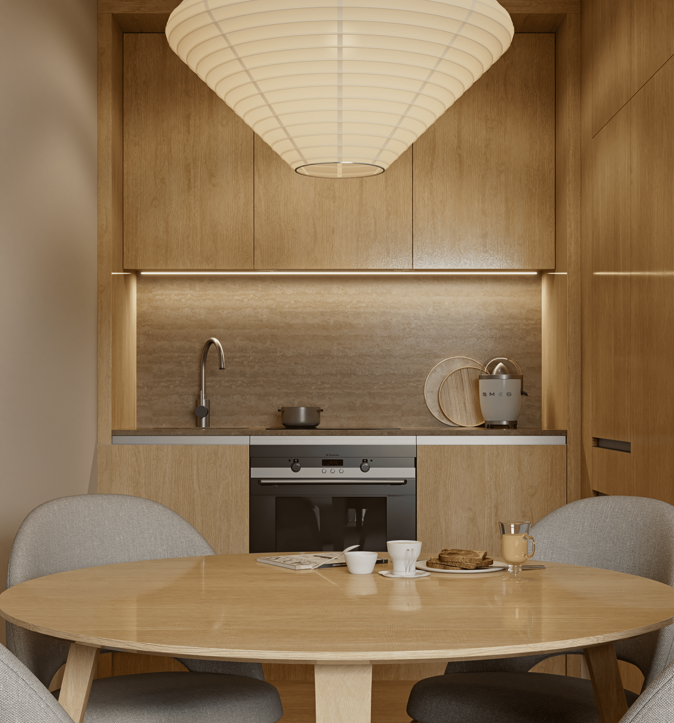 Modern kitchen with light wood cabinets, a round dining table, grey chairs, and a large paper pendant light overhead.